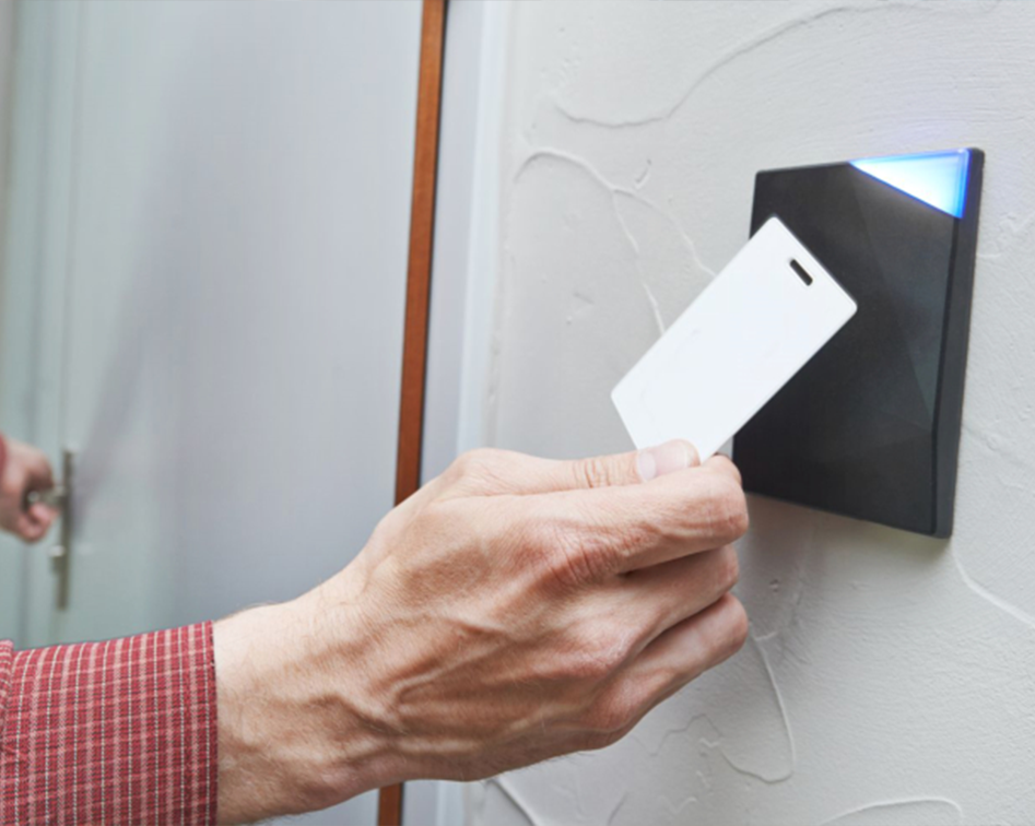 Man using an access control panel with keycard